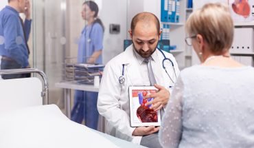 doctor-talking-about-efect-heart-attack-pointing-tablet-pc-senior-woman-examination_482257-8467